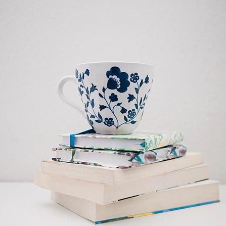 A cozy morning: steaming cup and open book await you