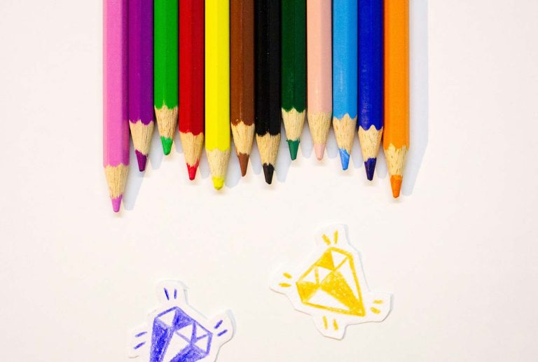 Crayons markers and paper help children create colorful drawings